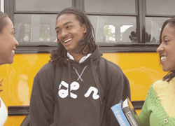 teenagers standing in front of bus