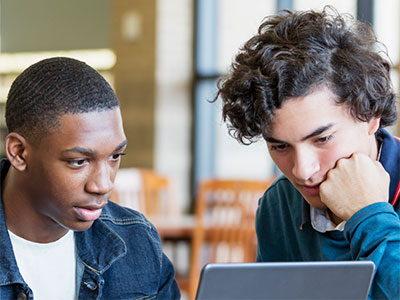 Two young adults looking at a computer screen