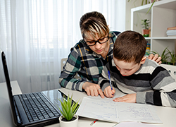 Mother helping son with homework