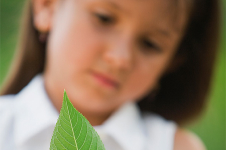 Girl holding leaf