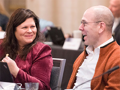 Two IACC Members talking during an IACC meeting