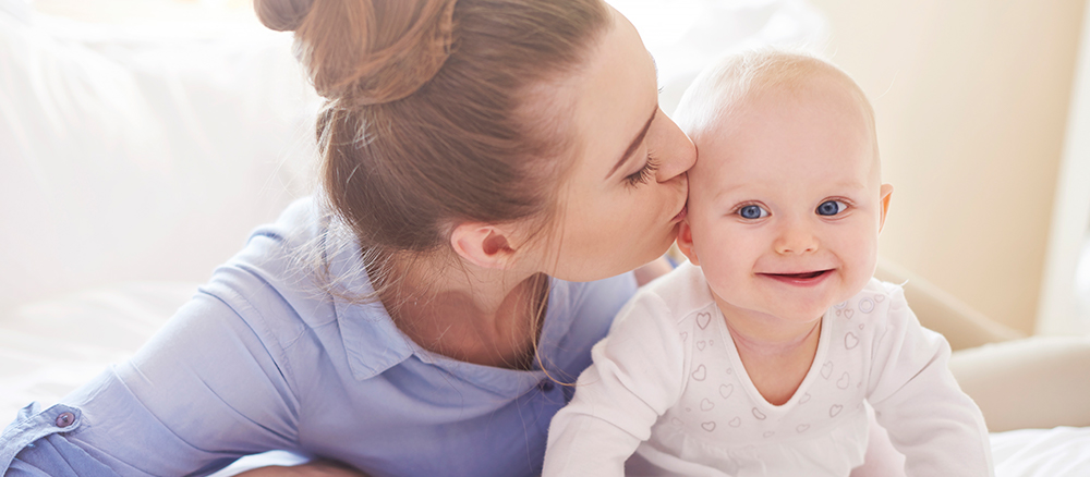Mother kissing baby